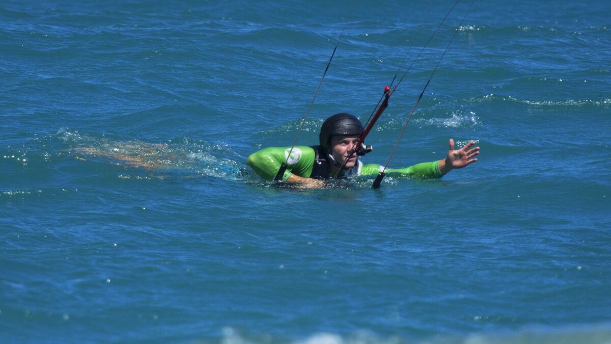 student learning bodragging with a kite in the water