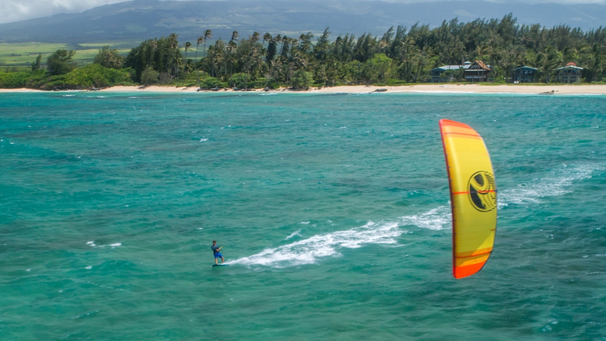 flying a kite while kitesurfing in nature
