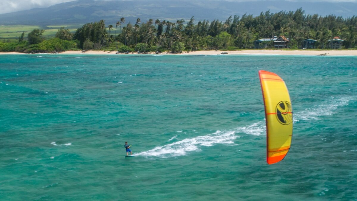 flying a kite while kitesurfing in nature